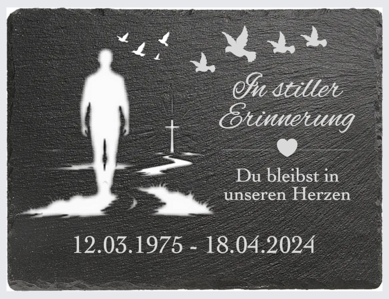 Gedenktafel mit einem Silhouettenbild, Herz und Tauben, Datum und Text zur Erinnerung.